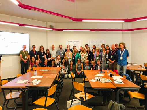 Nach der Workshop-Session finden sich alle Teilnehmer:innen für ein Gruppenfoto vor dem Venice Agreement Poster zusammen (Foto: Nicole Puschel)